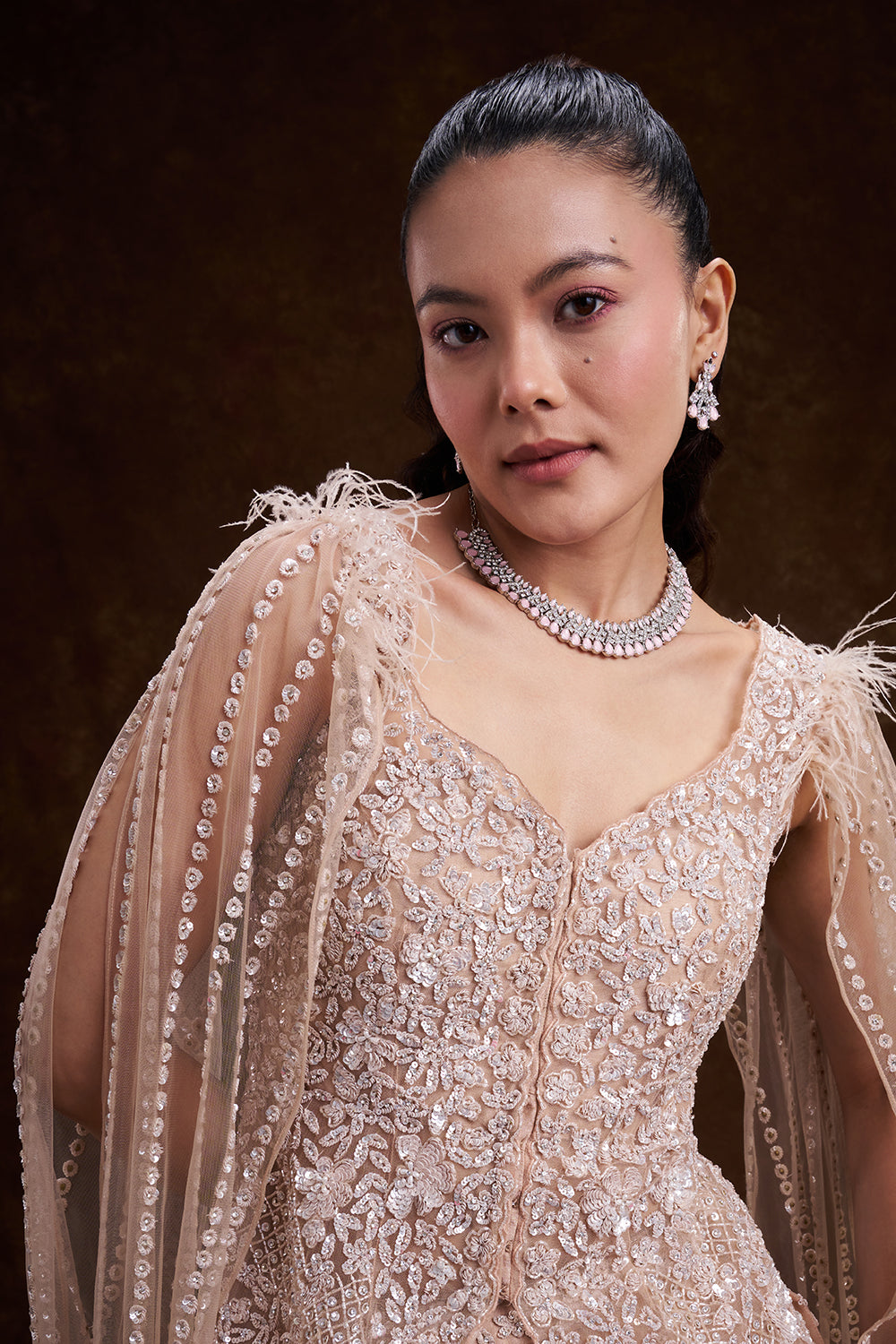 Beige Golden Net Bridal Lehenga with Feathered Cape Detail