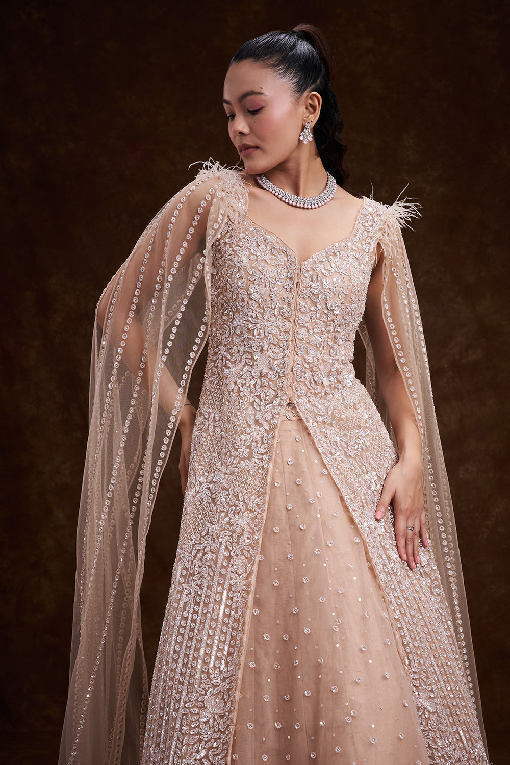 Beige Golden Net Bridal Lehenga with Feathered Cape Detail