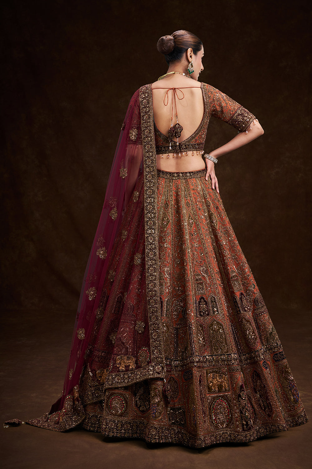Copper Rust Raw Silk Bridal Lehenga with Palatial Motifs and Zardozi Work